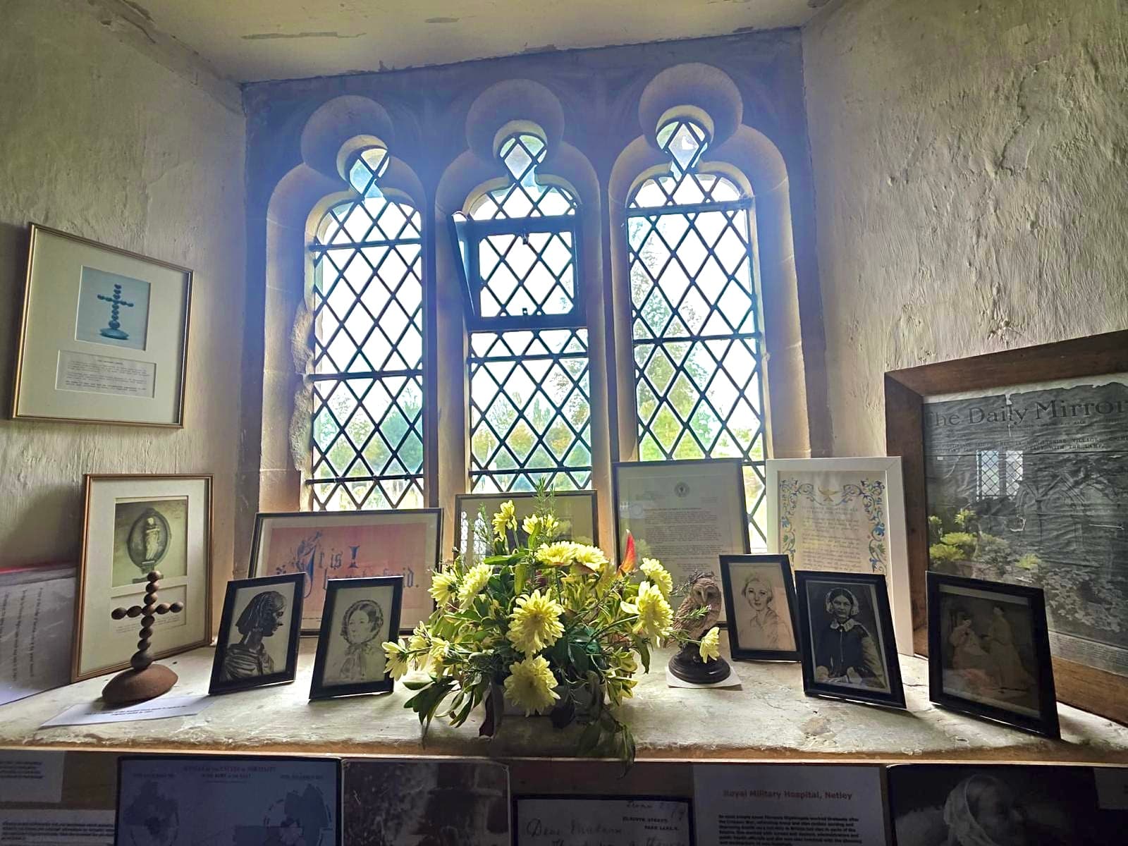 A display of portraits, documents and flowers commemorating Florence Nightingale.